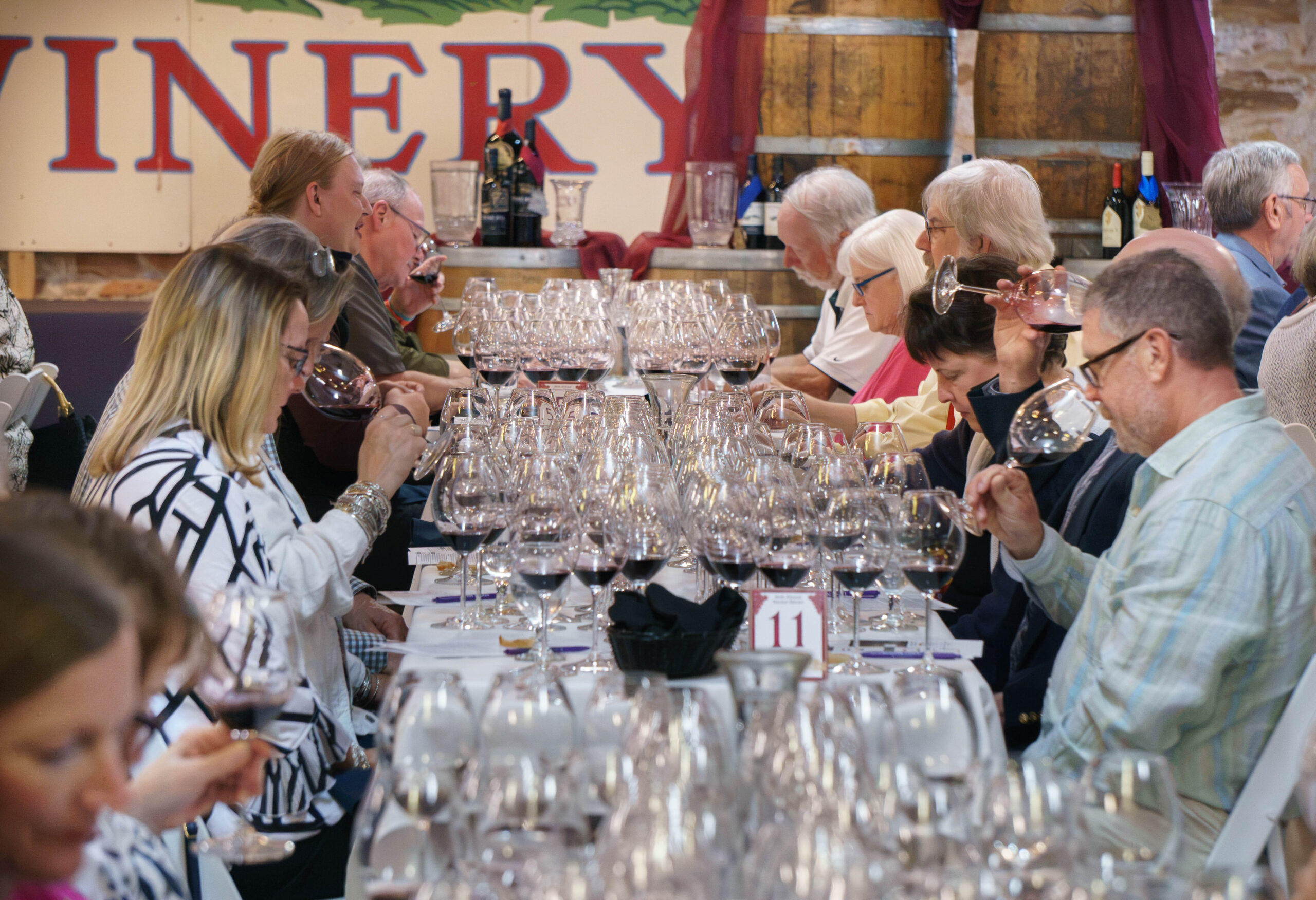 Guests tasting ten vintages of Norton at long tables during the Norton Dinner at Stone Hill Winery