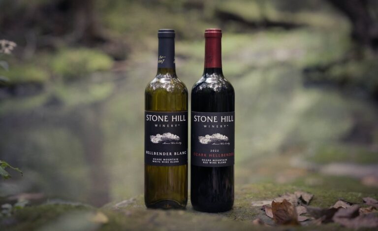 Bottles of Hellbender Blanc and Ozark Hellbender on a rock beside a clear Ozark stream