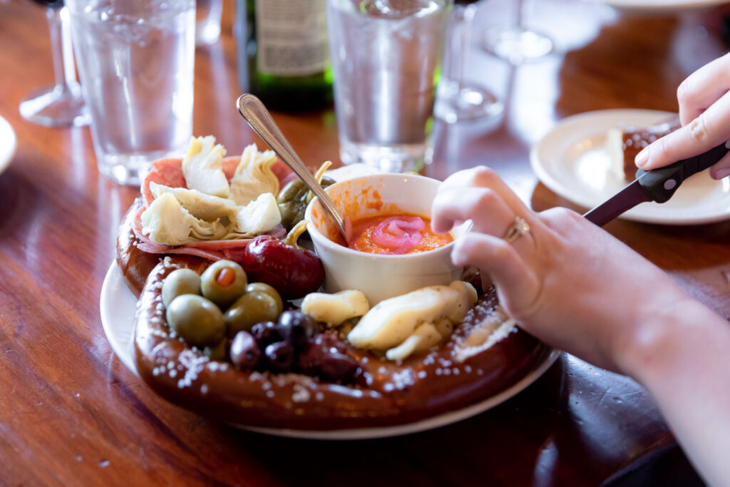 Soft pretzel ring with salami, olives, artichokes and dip at Vintage 1847 Restaurant